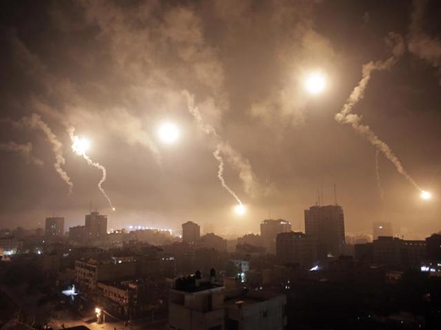 Israeli forces' flares light up the night sky of Gaza City on early Tuesday, July 29, 2014. A truce between Israel and Hamas militants in Gaza remained elusive as diplomats sought to end the fighting at the start of the Eid al-Fitr holiday, marking the end of the Muslim holy month of Ramadan. (AP Photo/Khalil Hamra)