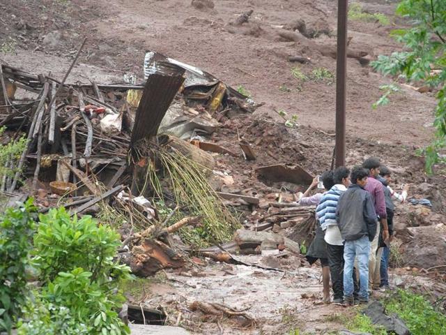 In-this-handout-photograph-released-by-the-Maharashtra-chief-minister-s-office-excavators-dig-through-mud-and-debris-at-the-scene-of-a-landslide-in-Malin-village-in-Pune-AFP-photo