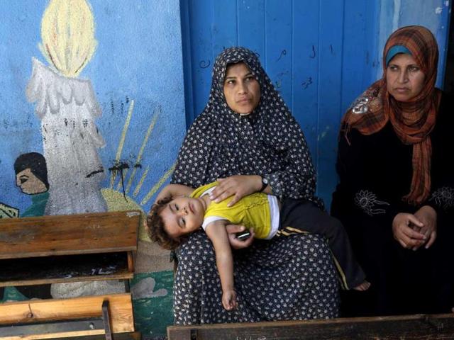 Palestinian women rest at the Abu Hussein UN school in the Jebaliya refugee camp in the northern Gaza Strip. The school was hit by a series of Israeli artillery shells. (AP Photo)