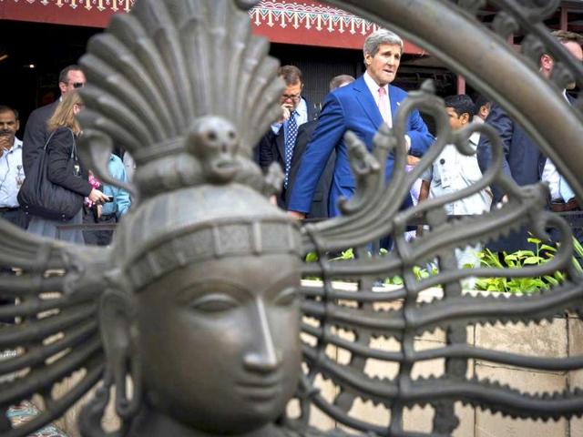 US secretary of state John Kerry walks past a statue after a visit to the central cottage industries emporium marketplace in New Delhi. AFP