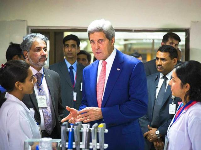 US secretary of state John Kerry speaks with graduate students about their work at the Indian Institute of Technology. AFP