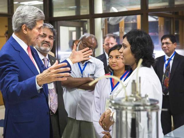 US secretary of state John Kerry speaks with graduate students about their work at the Indian Institute of Technology. AFP