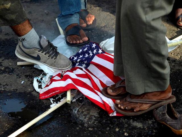 Sri Lankan activists from the leftist Front Line Socialist party step on a US flag during a demonstration denouncing Israeli action in Gaza, in Colombo. (AFP Photo)