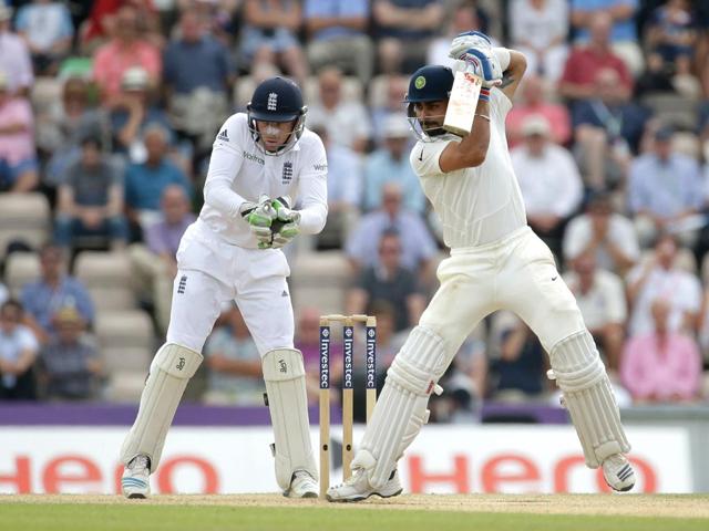 India's Virat Kohli hits a shot watched by test debutant England wicketkeeper Jos Buttler during the fourth day (AP Photo)