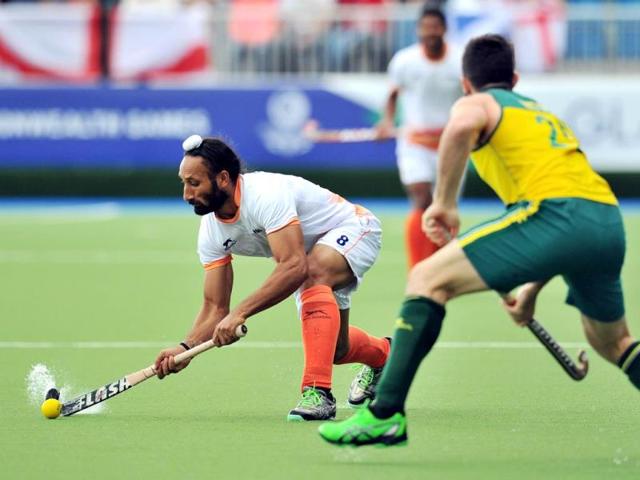 Sardar-Singh-L-passes-the-ball-past-Australia-s-Trent-Mitton-R-during-their-men-s-field-hockey-match-against-Australia-at-the-Glasgow-National-Hockey-Centre-at-the-2014-Commonwealth-Games-AFP-Photo Sardar-Singh-L-passes-the-ball-past-Australia-s-Trent-Mitton-R-during-their-men-s-field-hockey-match-against-Australia-at-the-Glasgow-National-Hockey-Centre-at-the-2014-Commonwealth-Games-AFP-Photo