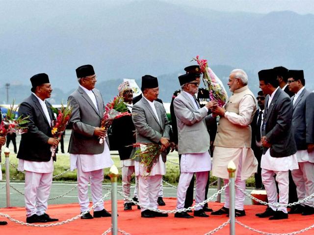 Prime minister Narendra Modi being welcomed by his Nepalese counterpart Sushil Koirala and his cabinet ministers on arrival at Tribhuvan International Airport in Kathmandu, Nepal. (PTI photo)