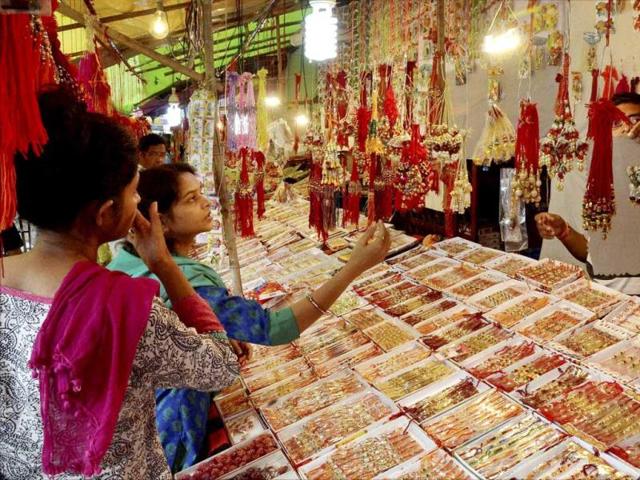 Women buy Rakhis in Bhopal on Monday. (PTI photo)