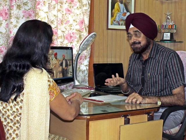 Colonel-Gursewak-Singh-engaged-in-a-discussion-with-a-client-at-his-office-in-Manimajra-Abhishek-Seth-HT