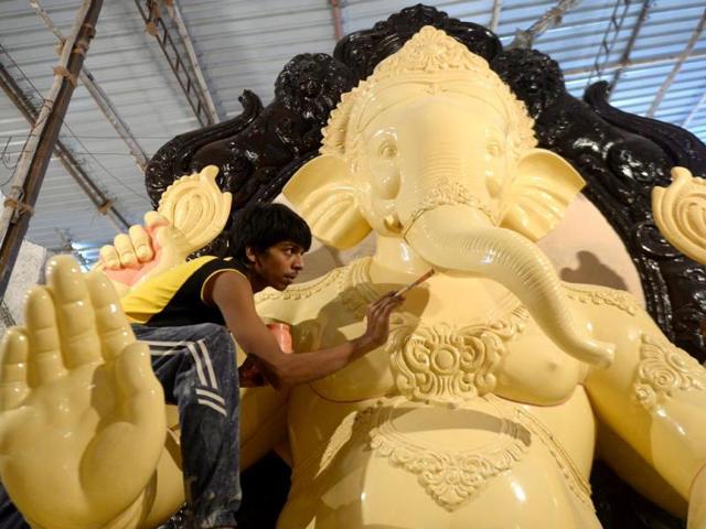 An artist works on an idol of elephant-headed Hindu god Lord Ganesh at a workshop in Mumbai. (AFP photo/Punit Paranjpe)