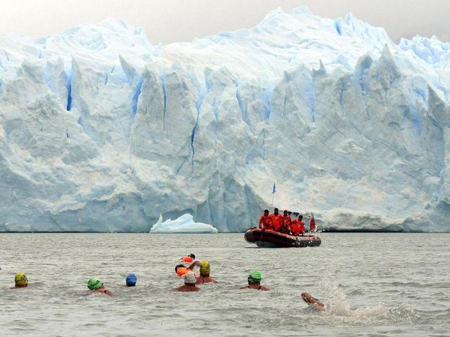 Competitors take part in the Winter Swimming Festival race in Argentino Lake, as the Perito Moreno glacier is seen in the background, near the Patagonian city of El Calafate. (Reuters)