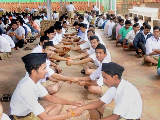 RSS members tie rakhis on each others' wrists on Raksha Bandhan at Gokul Garden in Hubli. (PTI Photo)