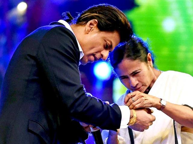 West Bengal chief minister Mamata Banerjee ties rakhi on the wrist of Bollywood actor Shahrukh Khan to celebrate Raksha Bandhan during a Kolkata Police programme in Kolkata. (PTI Photo)