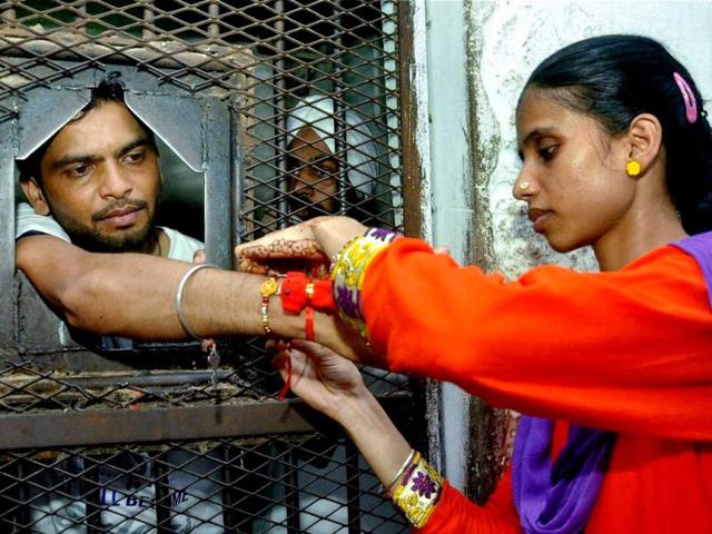A girl ties a rakhi to her prisoner brother at the Patiala Central Jail on Raksha Bandhan. (PTI Photo)