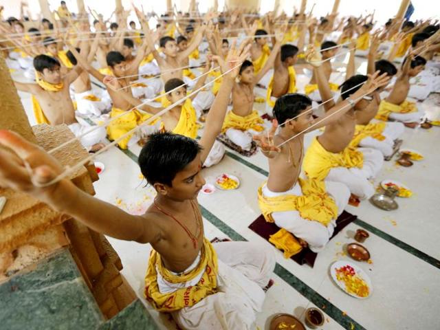 Brahmins hold "Janeu" (sacred thread), also called "Yagnopavit", as they perform prayers at a temple on the occasion of the Raksha Bandhan festival in Ahmedabad. (Reuters)