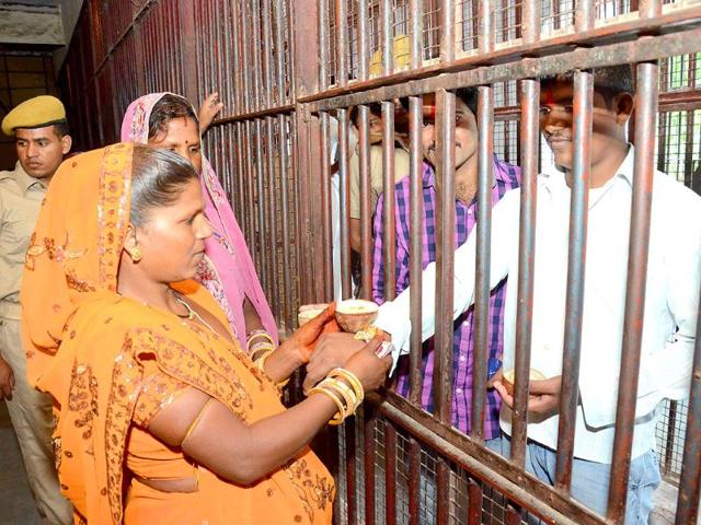 Sisters tie rakhi on the wrist of their imprisoned brothers on the occassion of Raksha Bandhan at the central jail, in Kota, Rajasthan. (HT photo)