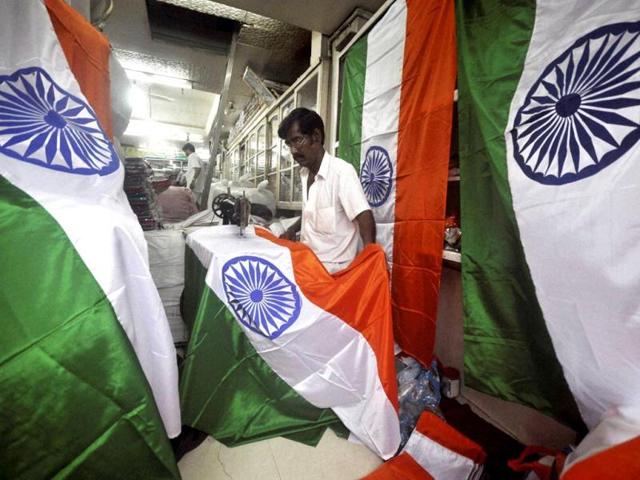 A man is stitching national flags ahead of Independence Day function in Agartala. PTI Photo