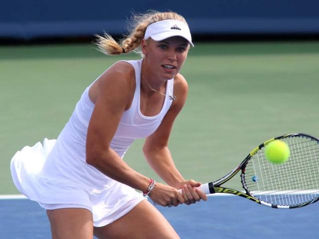 Caroline Wozniacki returns a volley to Magdalena Rybarikova at the Western and Southern Open tennis tournament on August 11, 2014, in Mason, Ohio. (AP Photo)