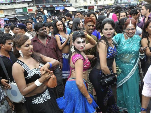 Eunuchs dance during a procession taken out during the month of Shravan for immersing a especially-grown wheat sapling (Bhujaria), in Bhopal on Tuesday. (Praveen Bajpai/HT photo)
