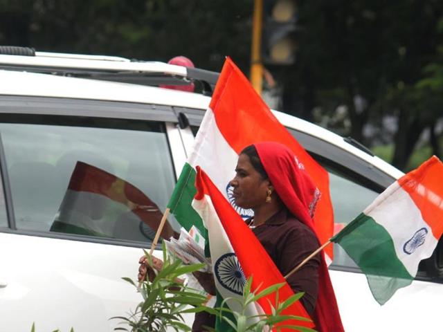 A woman sells flags ahead of Independence Day, in Indore on Tuesday. (Shankar Mourya/HT photo)
