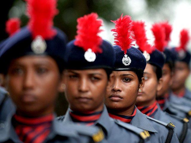 An armed women forces contingent wait to participate in the march past during the full dress rehearsal for the 68th Independence Day celebrations at The Red Road in Kolkata. (AFP Photo)
