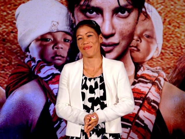 Boxer Mary Kom smiles as she poses during the music launch of the upcoming sports drama Mary Kom directed by Omung Kumar and produced by Sanjay Leela Bhansali in Mumbai on August 13, 2014. (AFP)