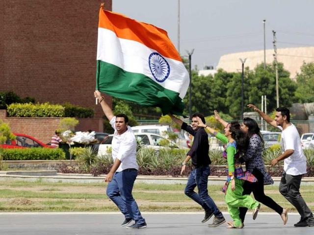 Students hold country flag while celebrating the Independence day weekend in Noida (Burhaan Kinu/HT Photo)