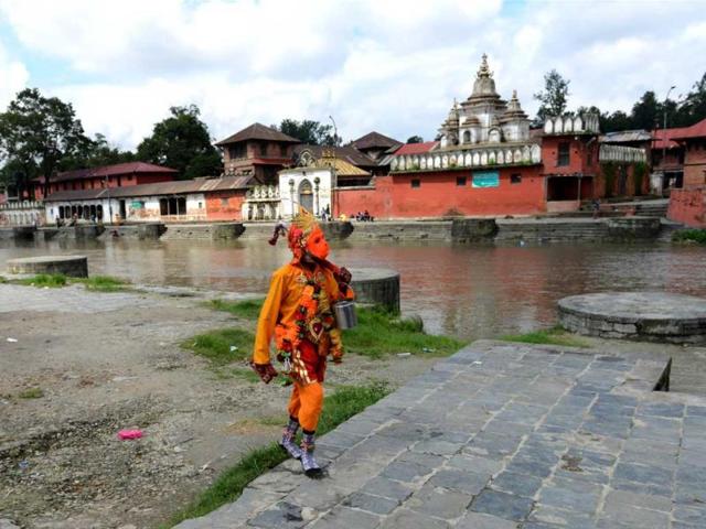 A Hindu Sadhu, dressed as Hanuman, walks during the Janai Purnima Festival at The Pashupatinath Temple in Kathmandu. The Janai Purnima Festival is known as the Sacred Thread Festival during which Hindu men, especially the Brahmans and Chettris perform their annual change of Janai (sacred thread), a yellow cotton string worn across the chest or tied around the wrist of the right hand. (AFP photo)