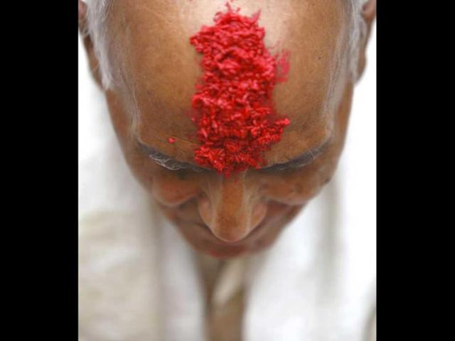 A Hindu priest's forehead is covered with 'tika', coloured powder and rice used as a blessing, during the Janai Purnima festival (sacred thread festival) at the premises of Pashupatinath Temple in Kathmandu. (Reuters)