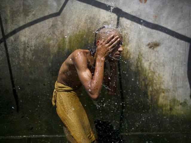 A Hindu priest takes a holy bath as part of a ritual during the Janai Purnima festival (sacred thread festival) at the premises of Pashupatinath Temple in Kathmandu. (Reuters)