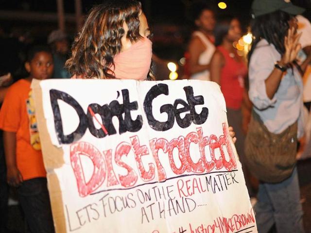 Riot police hurled tear gas and marched on rioters in Ferguson, the St Louis suburb wracked by race riots since police shot dead an unarmed black teenager on August 9. (AFP Photo)
