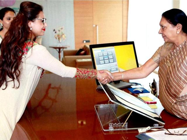 Actor Rani Mukerji greets Gujarat chief minister Anandiben Patel at the Gujarat Secretariat in Gandhinagar on Saturday. (PTI Photo)