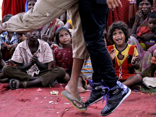 Under privileged children from slum watch people dance on Bollywood songs during a special summer camp organised for them by I-FA fashion institute at Lowadih slum in Ranchi. (Diwakar Prasad/HT Photo)