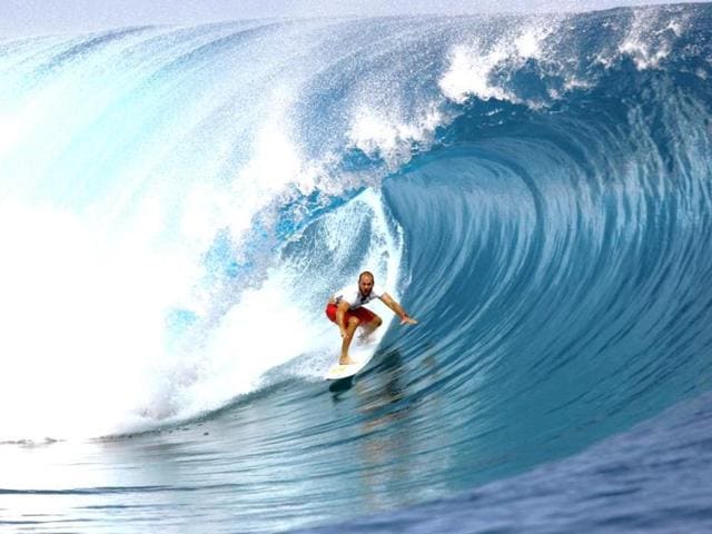 USA's CJ Hobgood rides a wave on August 18, 2014 during the 14th edition of the Billabong Pro Tahiti surf event, part of the ASP (Association of Surfing Professionals) world tour, in Teahupoo, on the French Polynesian island Tahiti. (AFP Photo)