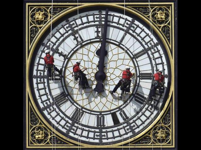 Cleaners abseil down one of the faces of Big Ben, to clean and polish the clock face, above the Houses of Parliament, in central London August. (Reuters) Cleaners abseil down one of the faces of Big Ben, to clean and polish the clock face, above the Houses of Parliament, in central London August. (Reuters)