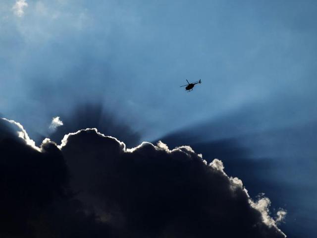 A police helicopter flies overhead as demonstrators take part in a peaceful march in reaction to the shooting of Michael Brown, near Ferguson, Missouri . (Reuters) A police helicopter flies overhead as demonstrators take part in a peaceful march in reaction to the shooting of Michael Brown, near Ferguson, Missouri . (Reuters)