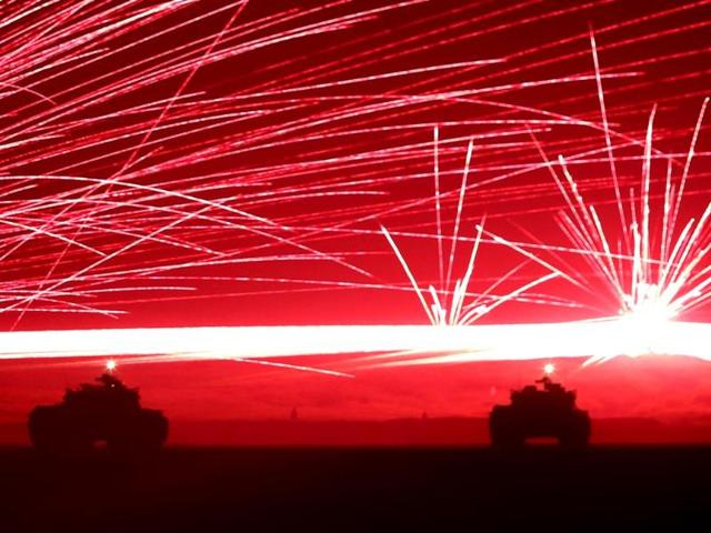 Tracer bullets ricochet off their targets as Japanese Ground Self-Defence Force tanks fire their machine guns during a night session of an annual training exercise at Higashifuji training field near Mount Fuji in Gotemba. (Reuters) Tracer bullets ricochet off their targets as Japanese Ground Self-Defence Force tanks fire their machine guns during a night session of an annual training exercise at Higashifuji training field near Mount Fuji in Gotemba. (Reuters)