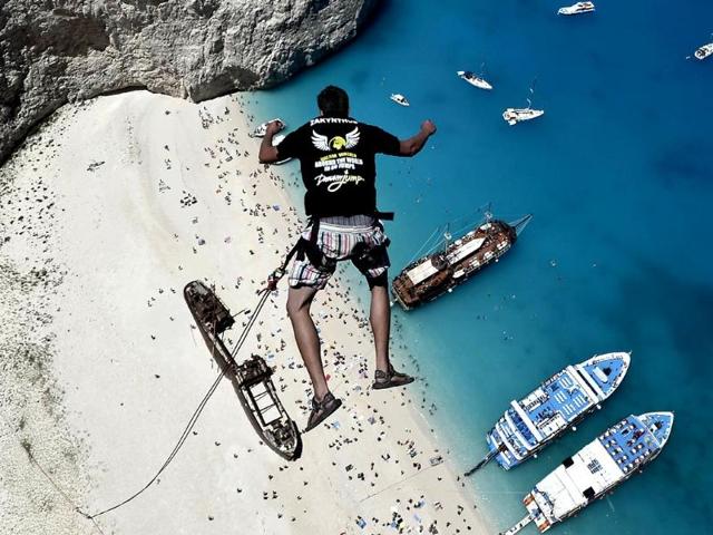 Lukas Michul, a member of the 'dream walker' group jumps from atop the rugged rocks overlooking the azure waters of Navagio beach, one of the Greece's most renowned leisure spots on the popular tourist island of Zakynthos. (AFP Photo) Lukas Michul, a member of the 'dream walker' group jumps from atop the rugged rocks overlooking the azure waters of Navagio beach, one of the Greece's most renowned leisure spots on the popular tourist island of Zakynthos. (AFP Photo)