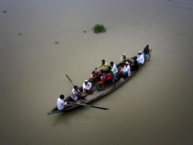 Villagers sail on a boat through a flood-affected area in Ashigarh village, about 70 kilometers east of Guwahati. (AP Photo) Villagers sail on a boat through a flood-affected area in Ashigarh village, about 70 kilometers east of Guwahati. (AP Photo)