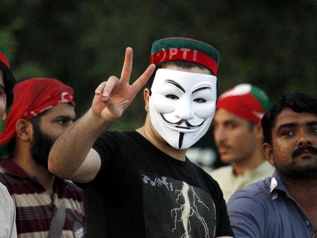 A supporter of Pakistan's cricketer-turned-politician Imran Khan makes victory sign prior to march toward parliament in Islamabad, Pakistan. (AP Photo)