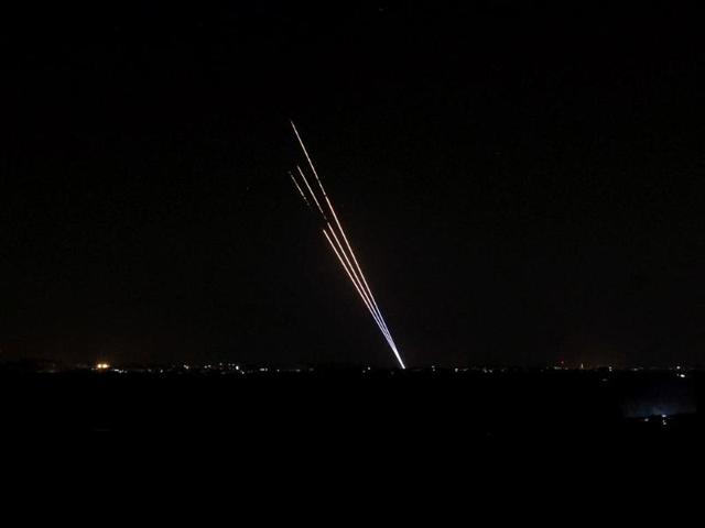 Light trails made by rockets fired from the Gaza Strip mark the night sky from the Israel-Gaza Border. (AFP Photo)