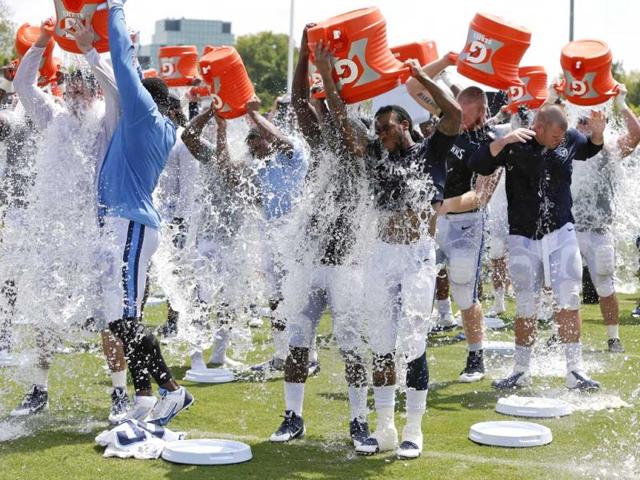 American football team, Tennessee Titans players take part in the ALS Ice Bucket Challenge and pour ice water over their heads after NFL football practice Wednesday.(AP Photo)