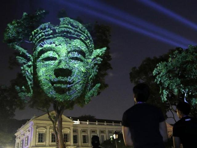 French artist Clement Briend's photographic light installation "Divine Trees", which features images of divine figures highly revered in Asian cultures projected on trees. (Reuters Photo)