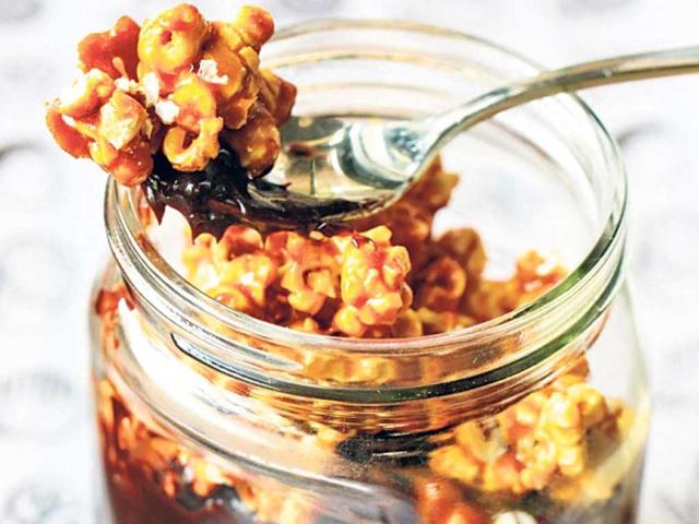 Caramel popcorn, perfect with mousse, hot chocolate, ice cream, cupcakes, shakes INGREDIENTS: 1 packet of buttered popcorn (make it at home with corn kernels and salted butter) 1.5 cup sugar 1 cup butter METHOD: In a pan, add sugar and place it on fire. Gently mix till it turns an amber colour. Remove from flame and add butter. Pour the caramel on the popcorn and mix well until each piece is coated with caramel. — Recipe by Chef Manu Chandra, Monkey Bar
