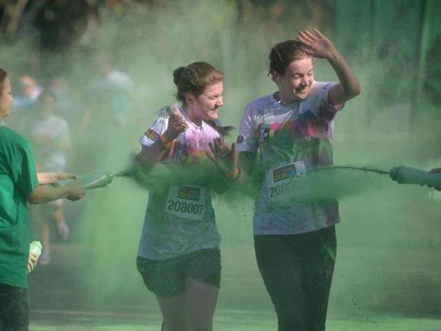 As the participants pass each kilometre marker, they are blasted with a different colour of harmless paint powder. (AFP Photo)