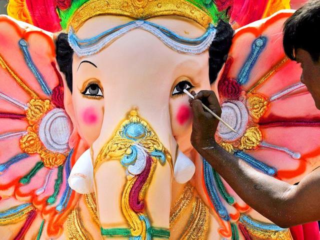 A sculptor gives finishing touches to idols of Ganesha on NH 24 near akshardham temple, has put a ban of use of idols made from plaster of Paris with a view to prevent pollution of rivers and ponds.(HT Photo/Raj K Raj)