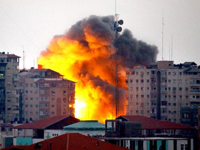 A ball of fire rises from a building following an Israeli air strike in Gaza City. (AFP Photo)