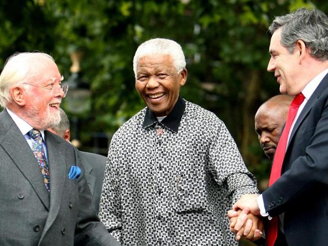 Britain's then Prime Minister Gordon Brown (R) and director Richard Attenborough assist South Africa's former President Nelson Mandela (C) to the podium, during the unveiling ceremony of a statue in Mandela's honour in London's Parliament Square in this 2007 photo. (AP)