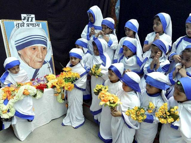 Children dressed as Mother Teresa offer prayers on the occaision of her birth anniversary in Bhopal on Tuesday. (PTI Photo)