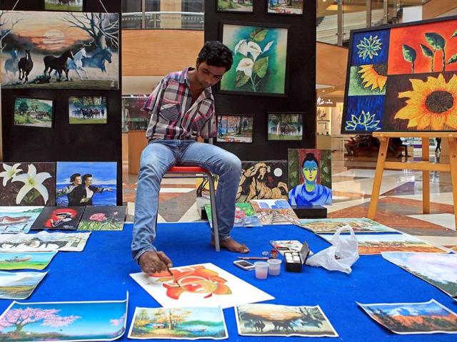 Nadeem Shaikh, a foot painter, paints Ganesha in Inorbit Mall at Malad in Mumbai. (Pratham Gokhale/HT Photo)