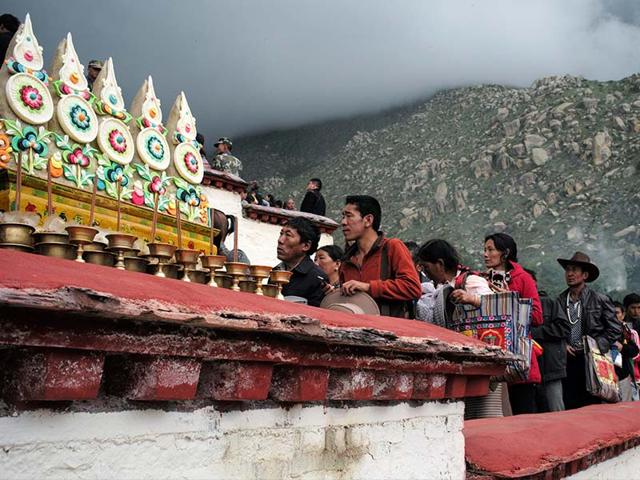 Tibetan Buddhists and tourists gather to view a huge Thangka (not pictured), a religious silk embroidery or painting displaying a Buddha portrait, during the Shoton Festival at Zhaibung Monastery in Lhasa, capital of southwest China's Tibet Autonomous Region, August 25, 2014.(REUTERS/China Daily)